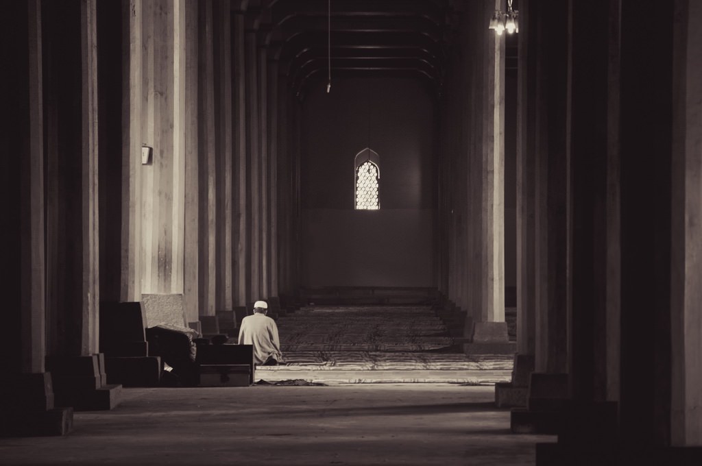 "Muslim Praying by Himself between 370 Wooden Pillars" by terbeck is licensed under CC BY-NC-SA 2.0