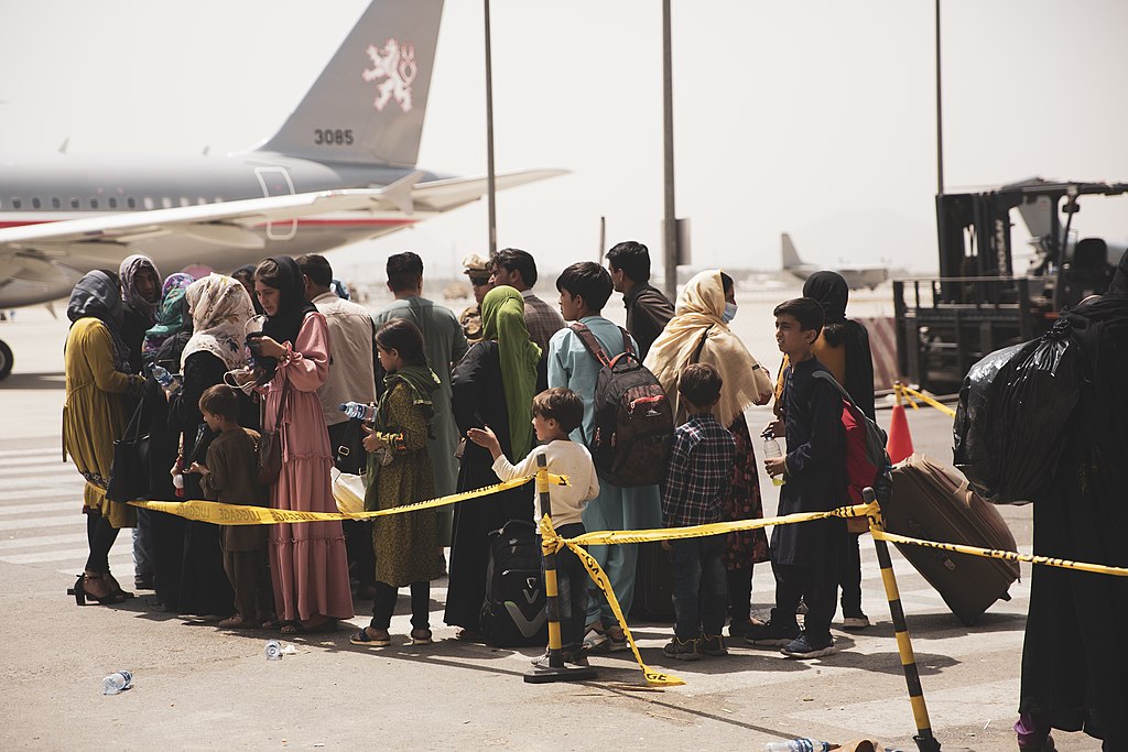 Civilians prepare to board a plane during an evacuation at Hamid Karzai International Airport, Kabul, Afghanistan, Aug. 18. U.S. Marines are assisting the Department of State with an orderly drawdown of designated personnel in Afghanistan. (U.S. Marine Corps photo by Staff Sgt. Victor Mancilla)
